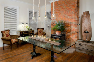 Country brick wall dining room photo in Other