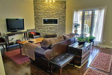 Mid-sized elegant enclosed dark wood floor and brown floor living room photo in San Diego with beige walls, a ribbon fireplace, a stone fireplace and a tv stand