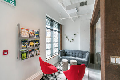 Inspiration for a mid-sized modern concrete floor and gray floor entryway remodel in Toronto with white walls and a glass front door