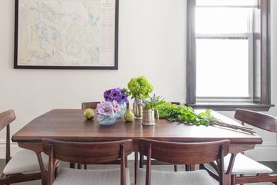 Enclosed dining room - mid-sized transitional dark wood floor and brown floor enclosed dining room idea in New York with white walls and no fireplace