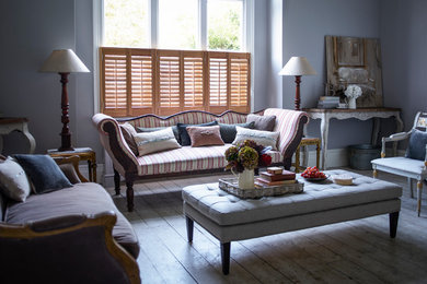 Inspiration for a mid-sized country living room in Sussex with light hardwood floors.