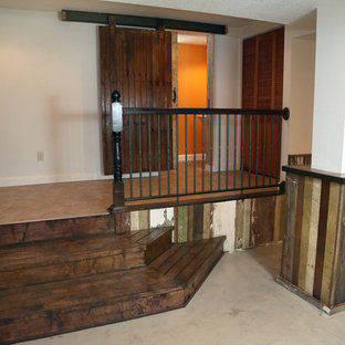 Inspiration for a large rustic look-out basement in Other with orange walls, concrete flooring and no fireplace.