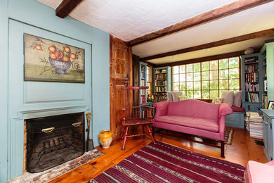 Inspiration for a large timeless formal and enclosed medium tone wood floor living room remodel in Boston with blue walls, a standard fireplace and a wood fireplace surround