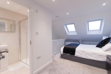 Large contemporary master bedroom in Essex with white walls, carpet and grey floor.