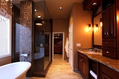Inspiration for a large contemporary gray tile and mosaic tile ceramic tile bathroom remodel in Orlando with a vessel sink, raised-panel cabinets, dark wood cabinets, solid surface countertops, a two-piece toilet and beige walls