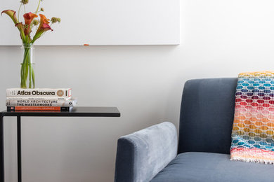 Example of a mid-sized trendy open concept medium tone wood floor and brown floor living room design in Boston with white walls
