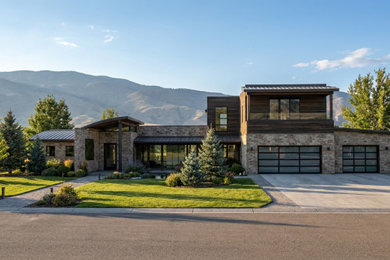 Example of a huge minimalist multicolored two-story mixed siding house exterior design in Salt Lake City with a shed roof, a metal roof and a black roof
