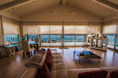 Large minimalist open concept medium tone wood floor living room photo in San Francisco with beige walls, a two-sided fireplace and no tv