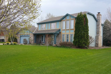 Inspiration for a timeless two-story metal exterior home remodel in Milwaukee