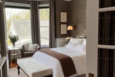 Inspiration for a large coastal master medium tone wood floor, brown floor and wallpaper bedroom remodel in Charleston with brown walls and no fireplace