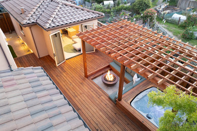 Deck - contemporary backyard ground level deck idea in San Francisco with a fire pit and a pergola