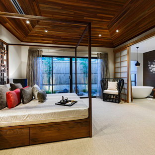 Foto di una grande camera matrimoniale etnica con pareti beige, moquette e nessun camino