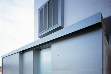 Photo of a large modern three-storey stucco white exterior in Other with a flat roof.
