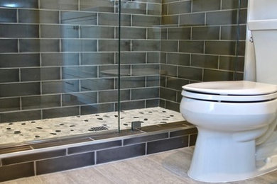 Inspiration for a large farmhouse kids' gray tile and ceramic tile porcelain tile and gray floor alcove shower remodel in Los Angeles with shaker cabinets, gray cabinets, a two-piece toilet, white walls, an undermount sink, quartz countertops and a hinged shower door