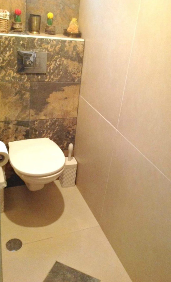 guest bathroom with slate and 60x60 tiles on walls