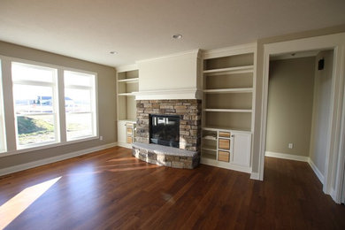 Elegant dark wood floor and brown floor living room photo in Detroit with beige walls, a standard fireplace and a stone fireplace