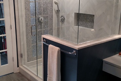 This is an example of a mid-sized traditional master bathroom in Raleigh with shaker cabinets, white cabinets, a corner shower, a two-piece toilet, blue walls, slate floors and a vessel sink.