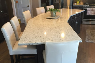 Large transitional l-shaped dark wood floor and gray floor open concept kitchen photo in New York with a single-bowl sink, recessed-panel cabinets, dark wood cabinets, stainless steel appliances, an island, quartzite countertops, brown backsplash and ceramic backsplash