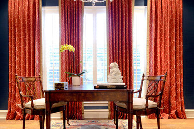 Study room - mid-sized traditional freestanding desk medium tone wood floor and brown floor study room idea in Dallas with blue walls