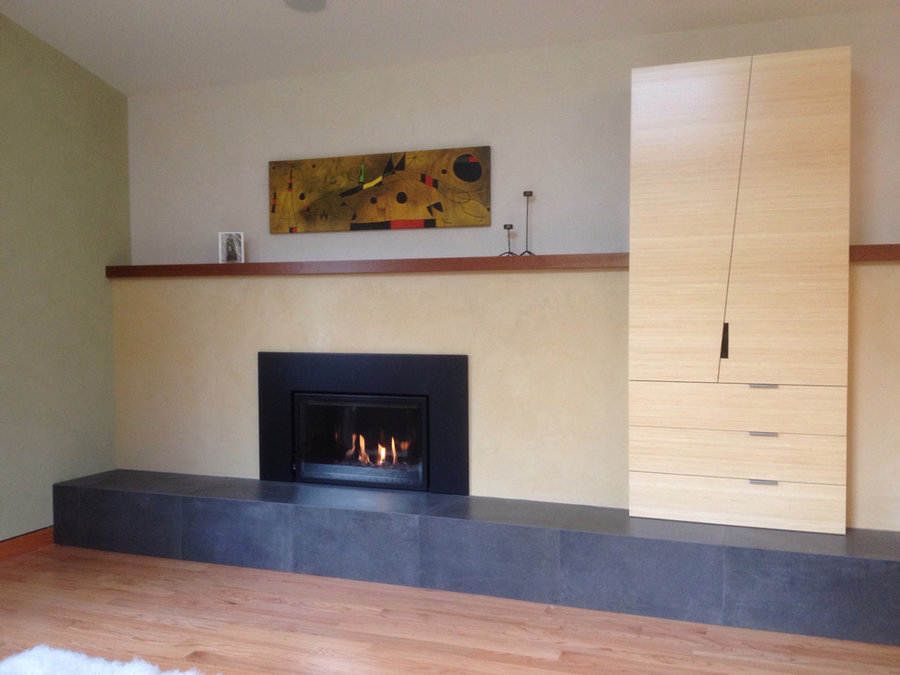 Gas fireplace with plaster surround and Sapele mantel (painting by Miro)