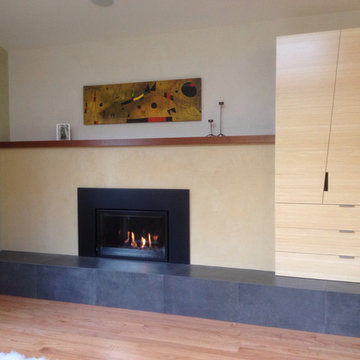 Gas fireplace with plaster surround and Sapele mantel (painting by Miro)