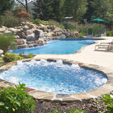 FREE FORM POOL WITH SEPARATE SPA WITH WATER FALL AND NATURAL STONE COPING