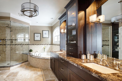 Example of a large transitional master beige tile travertine floor bathroom design in Chicago with an undermount sink, furniture-like cabinets, dark wood cabinets, marble countertops, a two-piece toilet and beige walls