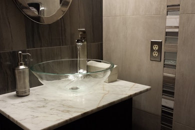 Bathroom - small contemporary gray tile and porcelain tile porcelain tile bathroom idea in Seattle with a vessel sink, flat-panel cabinets, dark wood cabinets, marble countertops, a two-piece toilet and gray walls