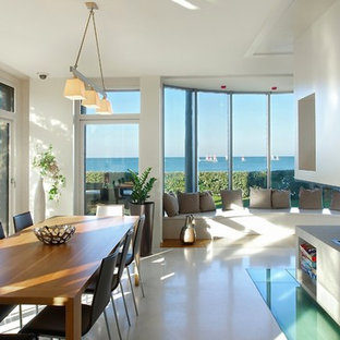 Idées déco pour une salle à manger ouverte sur le salon contemporaine de taille moyenne avec un mur blanc et une cheminée double-face.