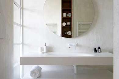 Medium sized contemporary ensuite bathroom in London with white cabinets, an integrated sink, a single sink, a floating vanity unit and a walk-in shower.