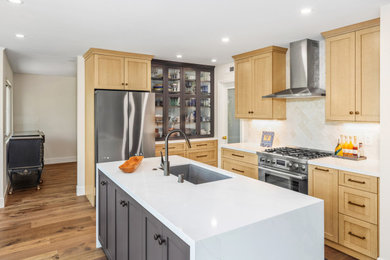 Small transitional l-shaped medium tone wood floor and brown floor eat-in kitchen photo in San Diego with a single-bowl sink, shaker cabinets, medium tone wood cabinets, quartz countertops, white backsplash, ceramic backsplash, stainless steel appliances, an island and white countertops