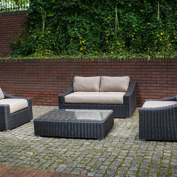 Toja Patio Furniture - Tuscan Love Seat Set - Red Brick Wall