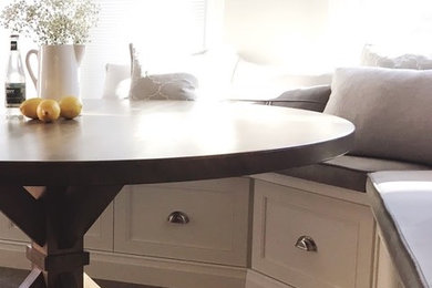Example of a large classic l-shaped vinyl floor and multicolored floor open concept kitchen design in Toronto with a farmhouse sink, shaker cabinets, white cabinets, granite countertops, white backsplash, ceramic backsplash, stainless steel appliances, an island and multicolored countertops
