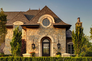 Photo of a traditional exterior in Detroit with stone veneer.