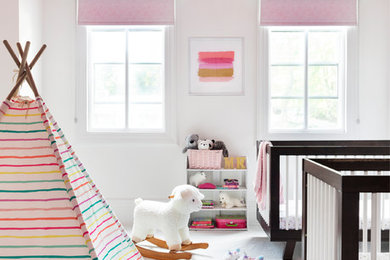 Mid-sized scandinavian nursery in New York with white walls, carpet and white floor for girls.