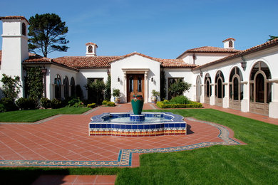 Large mediterranean white one-story stucco exterior home idea in San Francisco with a hip roof