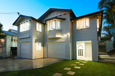 Large traditional two-storey grey exterior in Brisbane with wood siding.