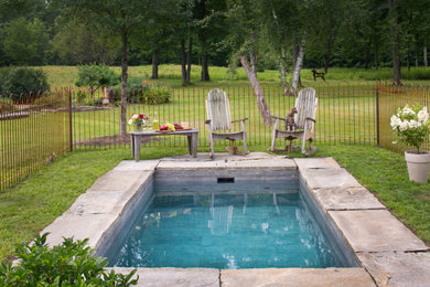 Example of a small classic backyard stone and rectangular natural hot tub design in Portland Maine