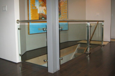 Photo of a contemporary hallway in Denver with beige walls, dark hardwood floors and brown floor.