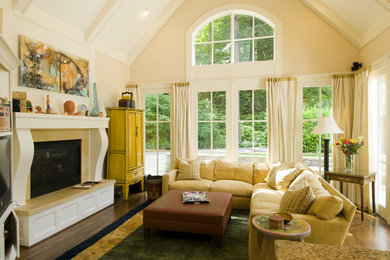 Inspiration for a mid-sized timeless enclosed dark wood floor and brown floor family room remodel in Portland with beige walls, a standard fireplace and a tile fireplace