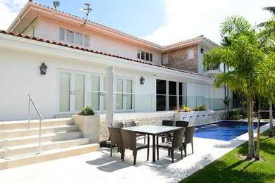Island style patio photo in Miami