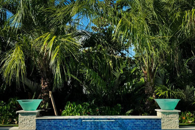 Pool landscaping - mid-sized tropical backyard stone and rectangular natural pool landscaping idea in Jacksonville