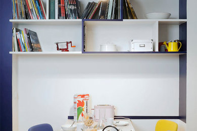 This is an example of a mid-sized contemporary open plan dining in Paris with white walls.