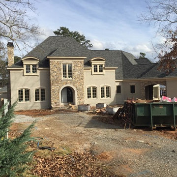 Progress photo with painted brick and stone on exterior