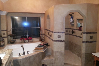 Example of a large mountain style master beige tile and porcelain tile bathroom design in Dallas with an undermount sink, raised-panel cabinets, white cabinets, granite countertops and beige walls
