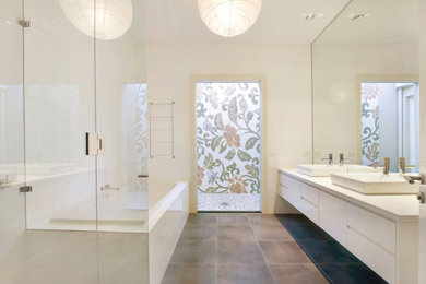 Design ideas for a contemporary bathroom in Melbourne with white cabinets, porcelain tile, porcelain floors and engineered quartz benchtops.