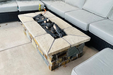 Example of a mountain style backyard patio design in Denver with a fire pit