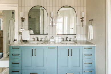 Trendy bathroom photo in San Diego with blue cabinets