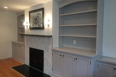Living room library - mid-sized traditional open concept light wood floor and brown floor living room library idea in New York with white walls, a standard fireplace, a stone fireplace and a media wall