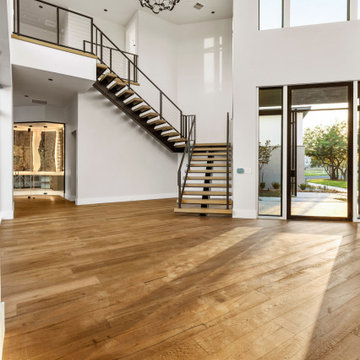 Modern Floating Staircase with Contemporary Metal Railing and Warm Wood Finishes